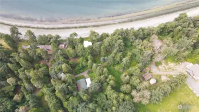 View showing beach, house and pole barn (white roofs)