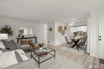 Living room view into dining area and kitchen. Fresh interior paint throughout.