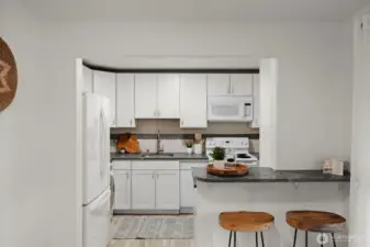 The kitchen has updated kitchen and backsplash. There is also space on the mini island for two barstools.