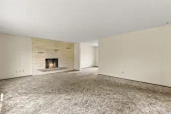 Bring the cozy! A wood-burning fireplace anchors this large upstairs living room, framed by oversized windows and plush 70s carpet that's basically begging for a glow-up.