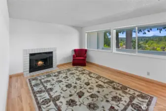 Living room with Wood burning fireplace. View out across the deck is the one seen in previous photo
