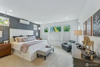 Serene primary bedroom with a mini split for comfort and plush carpeting. Top down - bottom up blinds for privacy.