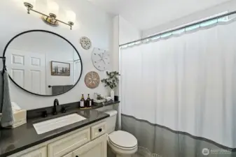 The full bath is adjacent to the guest room.
