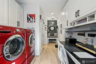 Looking back at the entry to the laundry is the barn door to the left that leads to the kitchen, a handy seating bench to drop your bags and shoes and the garage entry is to the right. Truly a thoughtfully designed space!