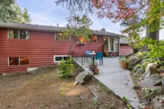 Back of home with patio overlooking the backyard