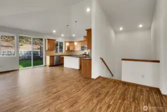 The open floor plan with vaulted ceilings creates a spacious atmosphere in the main living area on the upper level.