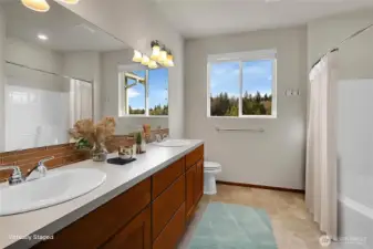 Spacious primary bath with dual vanity providing lots of storage and counter space. Virtually staged.