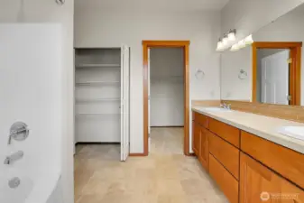 Large linen closet and walk-in closet in the primary bath.