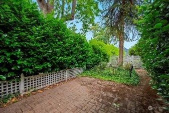 Large side yard with patio and English garden