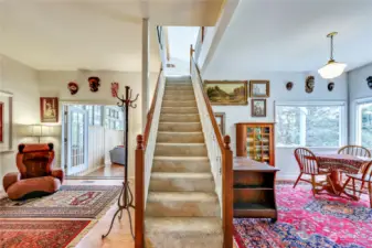 Standing at the fireplace wall you view the sunporch left and dining room with views across the meadow to Port Townsend Bay.