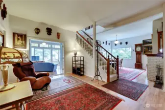 As you enter the front door you see the sunporch, dining room, and the stairs to the primary bedroom