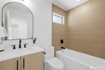 Lower level full bath. Model unit, finishes may vary.