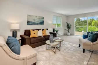 Roomy living room with a west facing deck. Photos taken when this was staged, it is now vacant.