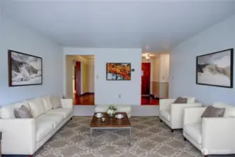 Virtually staged view of the living room looking toward the entry