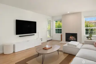 Living room features a sleek fireplace and opens out to one of two private balconies.