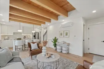 Living room.  Powder room under the stairs.  Garage door on the right hand side.