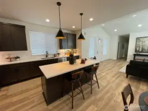 Large island has eating bar. Undermounted cabinet lights give off a special look.