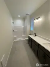 Primary bath with shower and double sinks. Linen closet also located in this room.