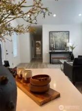 Kitchen island looking down the hallway to the master bedroom at the end.
