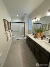 Primary bedroom ensuite bathroom with double sinks. Linen closet not shown.