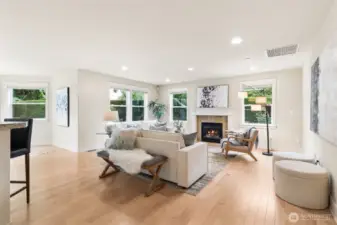 Spacious family room with hardwood floors and gas fireplace.