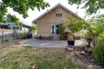 large poured concrete patio accessed from slider just off of kitchen