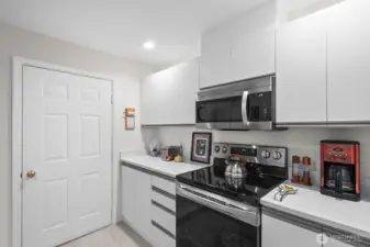 Electric stove and microwave with hood vented to outside.