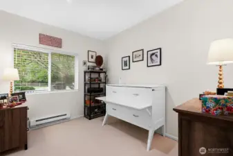 Guest bedroom with a full wall closet, big windows and space for a queen size bed.