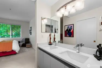 Quartz counters, updated lighting, double vanity with ample storage. The door leads to walk-in closet.