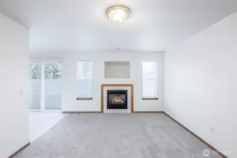 Gas fireplace in living room with space for television or decor