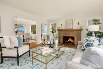 Spacious living room with gas fireplace, crown molding and lots of light.