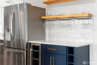 Wine fridge and oversized stainless steel fridge.