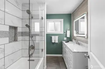 Main floor full bathroom with radiant floors, tiled bath and hard wired mirror.
