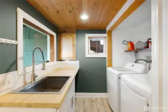 New washer and dryer with butcher block utility sink.