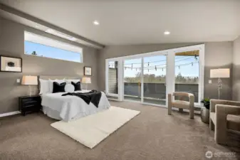 The spacious primary bedroom offers a peaceful retreat with large sliding glass doors that bring in natural light and open to a private balcony. The layout provides generous space for relaxation while enjoying the quiet surroundings of this Auburn, Washington home.
