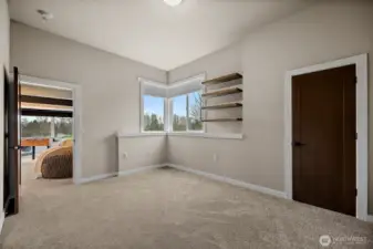 Additional bedroom in this River Rock home in Auburn features a bright layout with large windows, soft carpeting, and flexible space for guests, family, or a home office. The comfortable design provides privacy and easy access to nearby bathrooms and living areas.