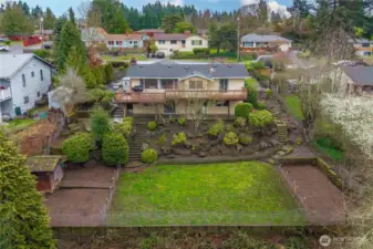 Gardens, a dog run, and tons of lawn in the professionally landscaped backyard.