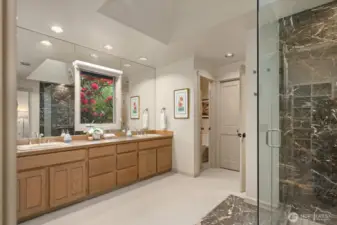 Spacious primary bathroom with walk in shower and lovely window outlook to the beautiful Rhododendron.