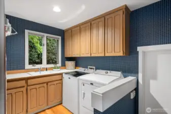 Convenient utility room adjacent to the kitchen and garage entrance.