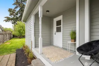 Side porch with entrance to root cellar on floor where furnace and hot water heater are located