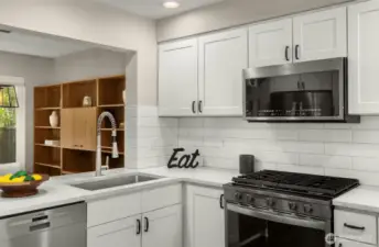Premium SS appliances, quartz counters and stylish backsplash