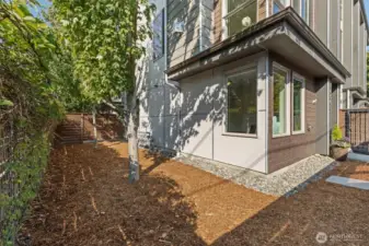 A rare fully fenced private side yard perfect for pets or an urban garden.