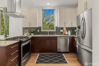 Stainless steel appliances and quartz counters in the large kitchen