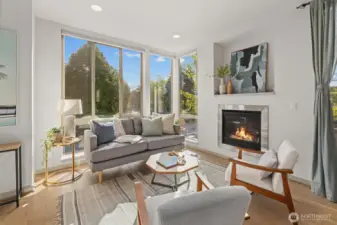 Generous living space highlighted by a gas fireplace and wall of windows