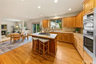 Well-appointed kitchen anchored by quality appliances including Bosch 800 Series oven and speed microwave, Amana gas cooktop, and Samsung dishwasher.
