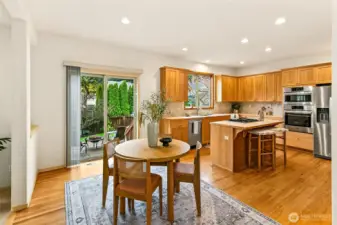 Dining area positioned for both formal gatherings and casual meals, with direct access to the outdoor living spaces.