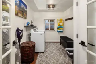 The convenient laundry room/mudroom, equipped with a brand new LG washer and dryer, located just off the garage entry—ideal for storing ski/snowboard gear.