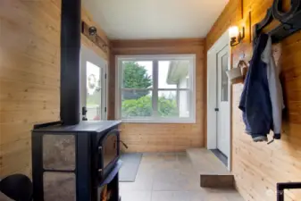 Entry mud room with stand alone wood stove that helps heat the house.