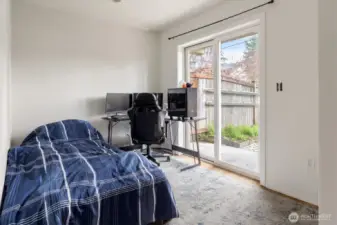 Lower level bedroom with access to fenced patio.