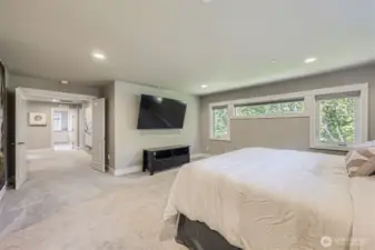 Oversized primary suite with green views and dramatic entryway.